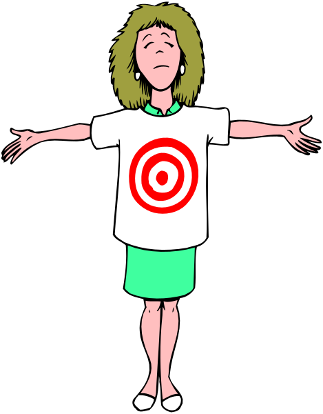 The cartoon shows a woman standing with her arms outstretched against a black background; she is wearing glasses on top of her head, has blonde hair pulled back into an updo, wears earrings and makeup, sports a white t-shirt that features a red bullseye design.