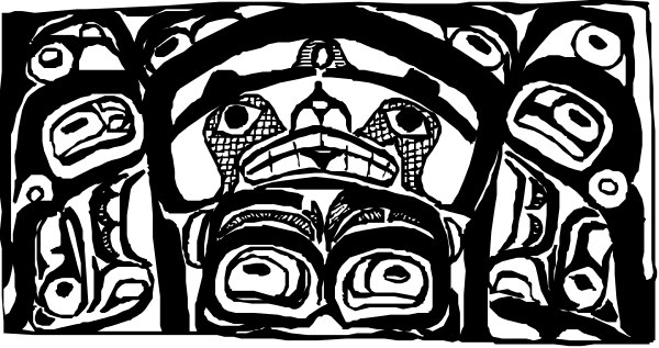 The black and white photo shows a collection of totem poles with various animal designs on them against an indistinct background that does not provide any additional context about location or time period.