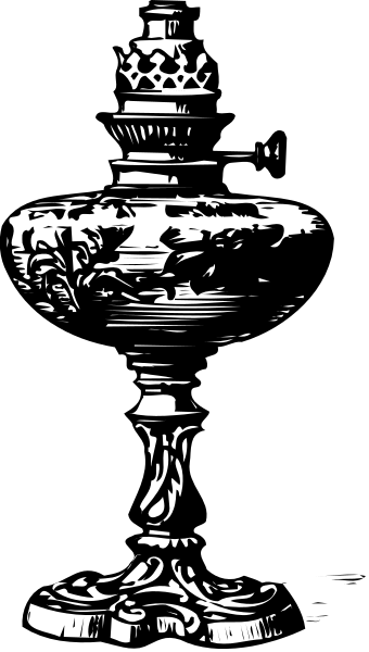 The black and white photo shows a tall vase with intricate designs on it placed against a dark background.