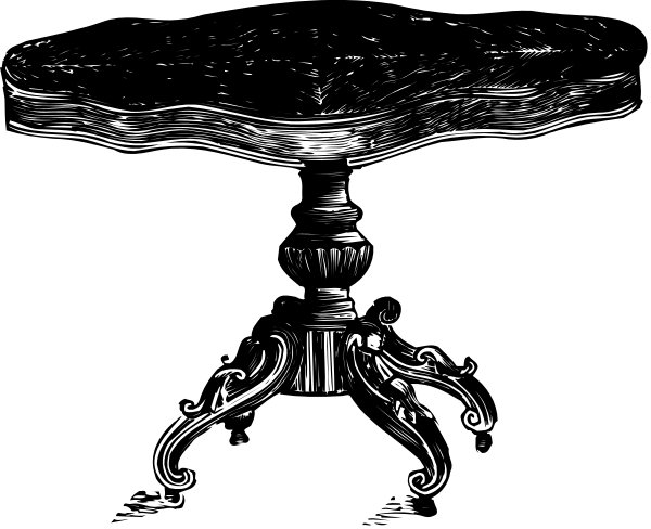 The black and white photo shows a table with an intricate design on top of it against a dark background.