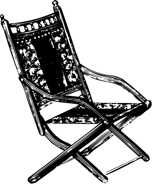 The black and white photo shows a folding chair with an intricate pattern on its backrest placed against a dark background.