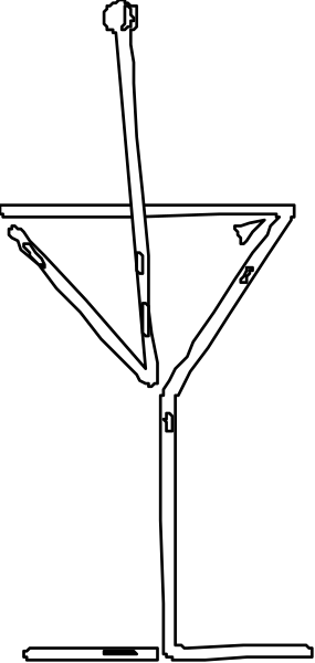 The image shows a black and white photo of an object that appears to be a stylized representation of a person with outstretched arms against a dark background.